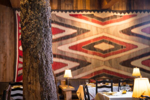 Close-up view of the historic tree in the middle of the Tree Room, with Native American art in the background.